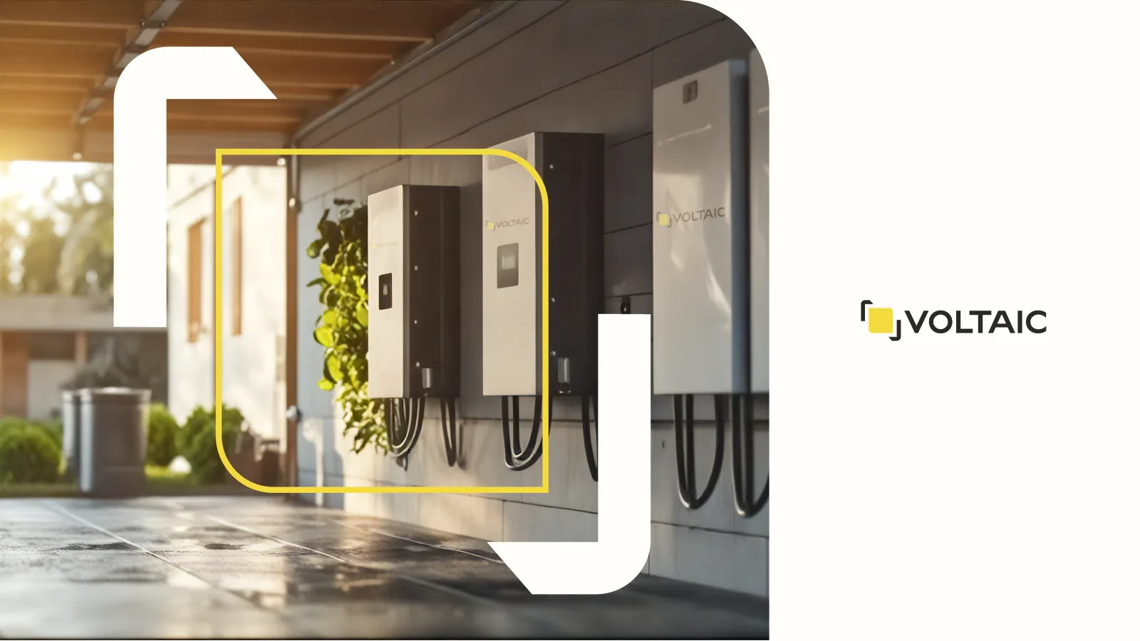 A Voltaic ad: a row of wall-mounted inverter and battery units in a modern garage, one unit framed in yellow with greenery, beside a white panel carrying the VOLTAIC lockup.